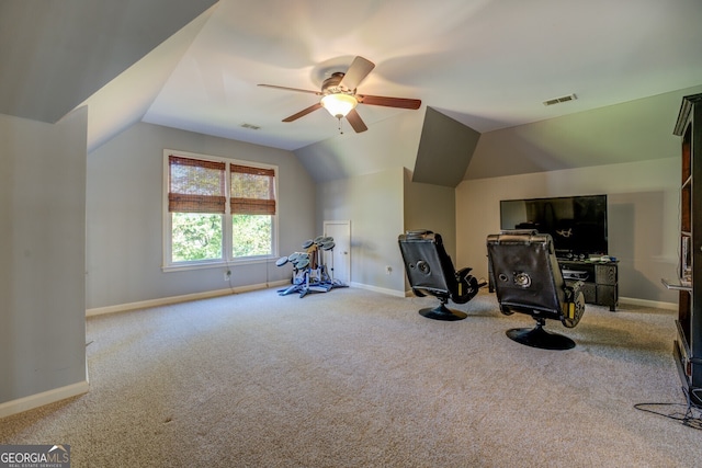 workout room with ceiling fan, light colored carpet, and lofted ceiling