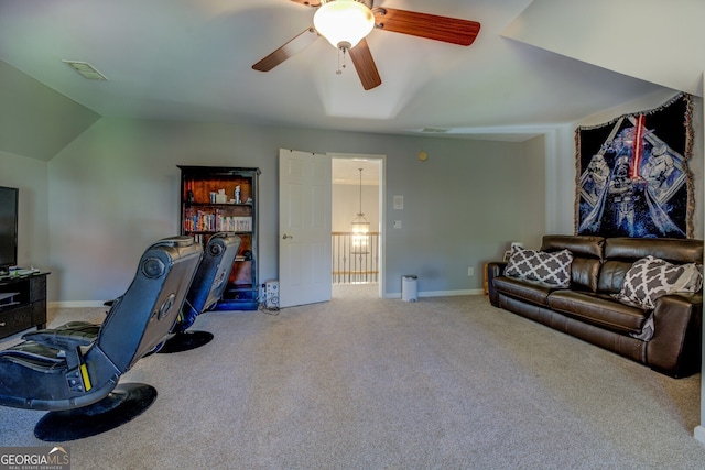 interior space featuring ceiling fan, carpet, and lofted ceiling