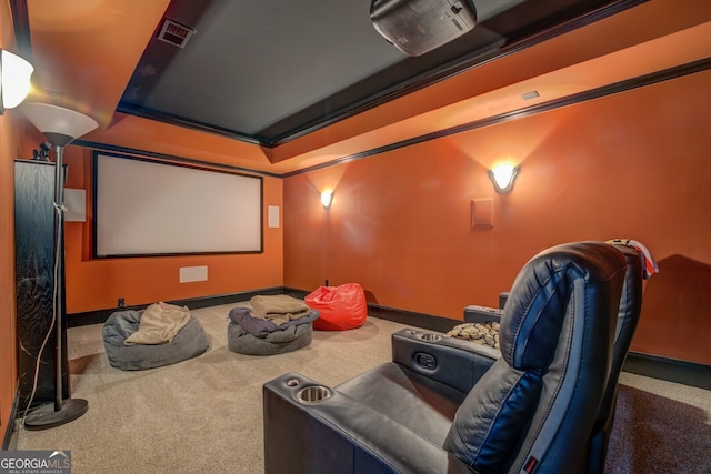 carpeted cinema room with crown molding