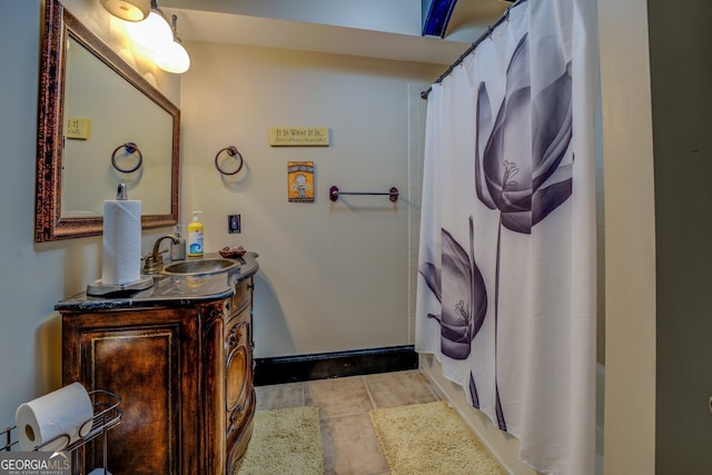 bathroom with a shower with curtain, vanity, and tile patterned floors