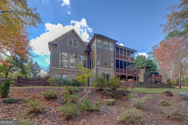 rear view of property with a sunroom