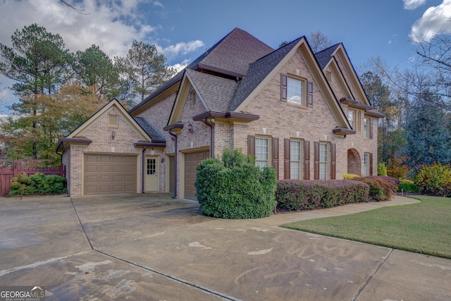 view of front of property featuring a front yard and a garage