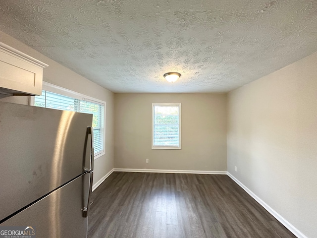 interior space featuring a textured ceiling and dark hardwood / wood-style flooring