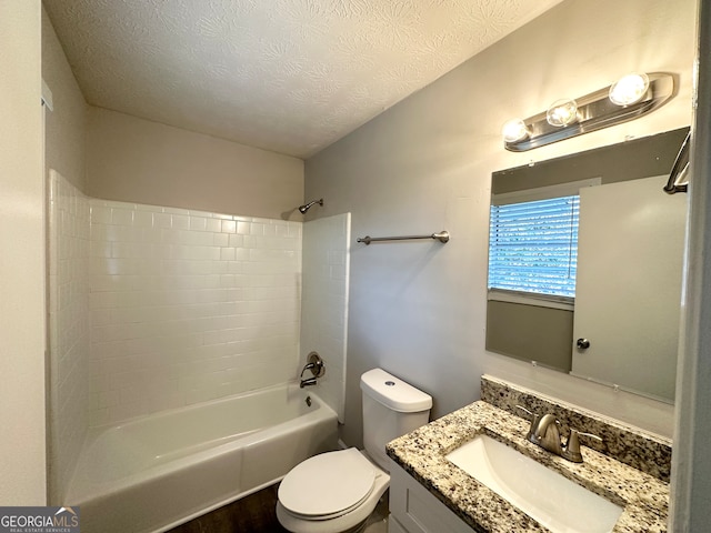 full bathroom with vanity, bathtub / shower combination, a textured ceiling, and toilet