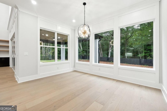 unfurnished sunroom featuring an inviting chandelier