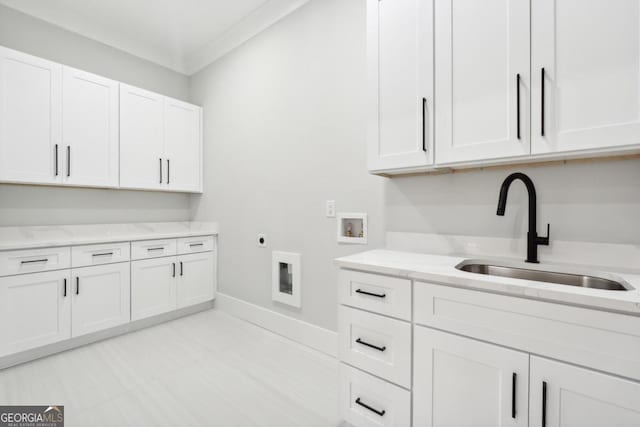 clothes washing area featuring sink, cabinets, washer hookup, electric dryer hookup, and ornamental molding