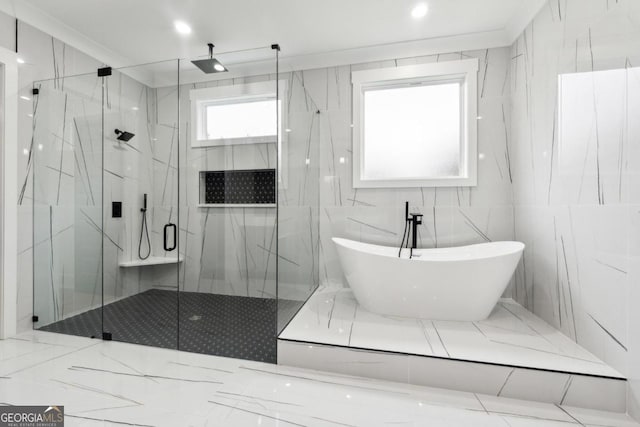 bathroom with tile walls and independent shower and bath