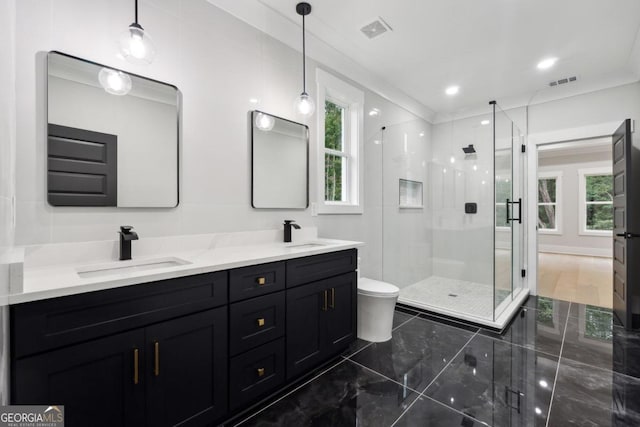 bathroom with toilet, an enclosed shower, and vanity