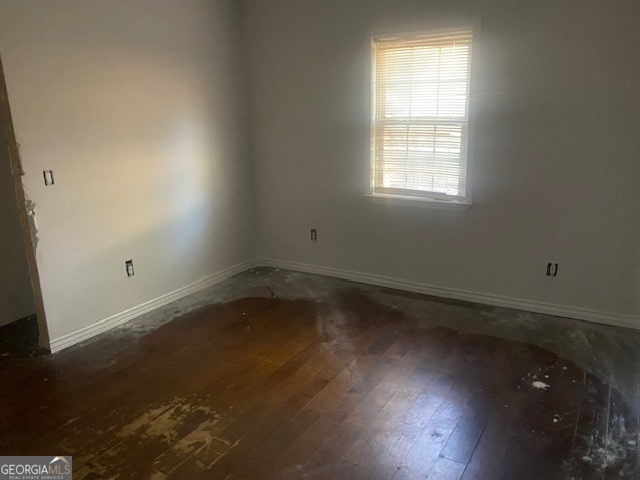 empty room with dark hardwood / wood-style floors