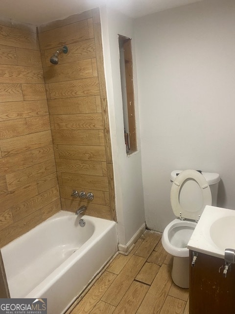 full bathroom with vanity, shower / bath combination, hardwood / wood-style flooring, and toilet