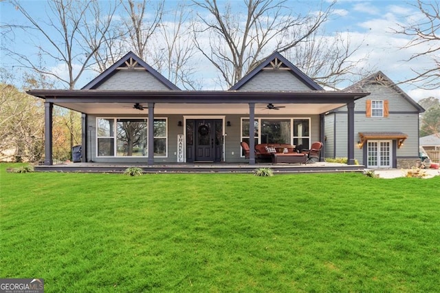 rear view of property with a lawn, outdoor lounge area, and ceiling fan