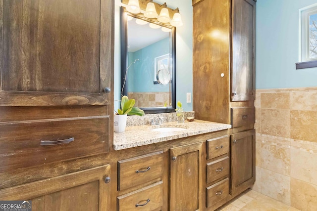 bathroom with vanity and tile walls