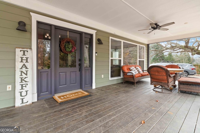 entrance to property featuring ceiling fan and a porch