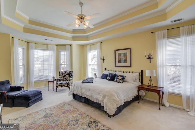 carpeted bedroom featuring a raised ceiling, visible vents, crown molding, and baseboards