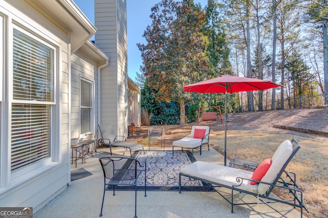 view of patio / terrace featuring fence