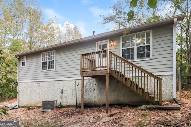 rear view of property featuring central air condition unit