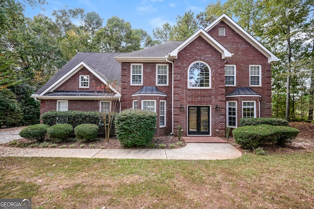 view of front of home featuring a front yard and french doors