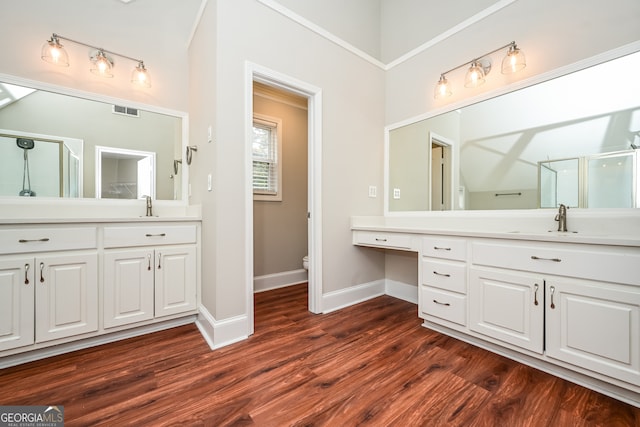 bathroom with walk in shower, toilet, vanity, and hardwood / wood-style flooring