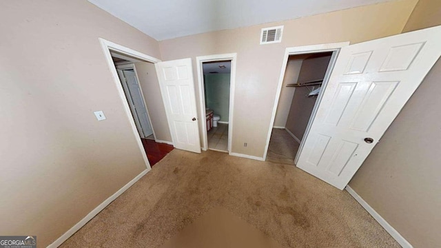 unfurnished bedroom with carpet and a closet