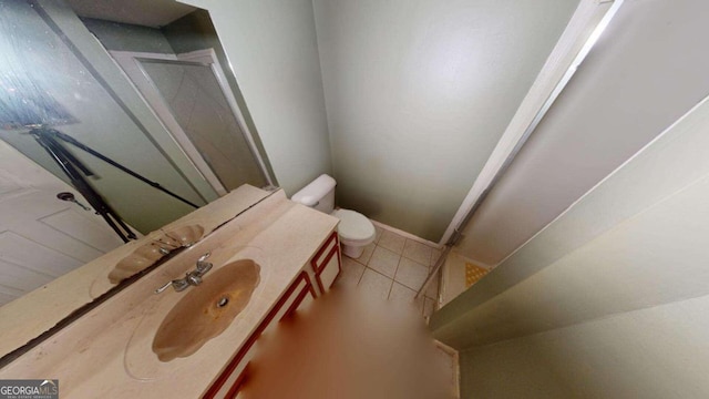 bathroom featuring toilet, vanity, and tile patterned floors