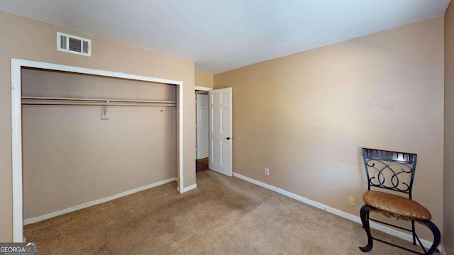 bedroom featuring light colored carpet and a closet