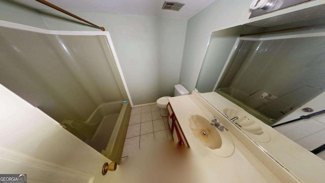 bathroom with toilet, vanity, tile patterned floors, and walk in shower