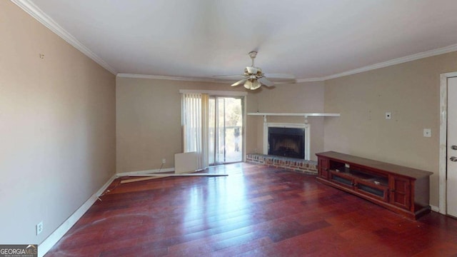 unfurnished living room featuring a fireplace, dark hardwood / wood-style flooring, ceiling fan, and crown molding