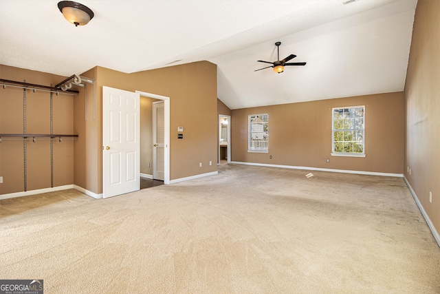 interior space with carpet, ceiling fan, and lofted ceiling