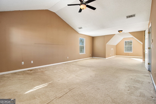 additional living space with carpet, vaulted ceiling, and ceiling fan