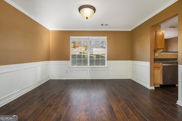 unfurnished dining area featuring a textured ceiling, dark hardwood / wood-style flooring, and ornamental molding