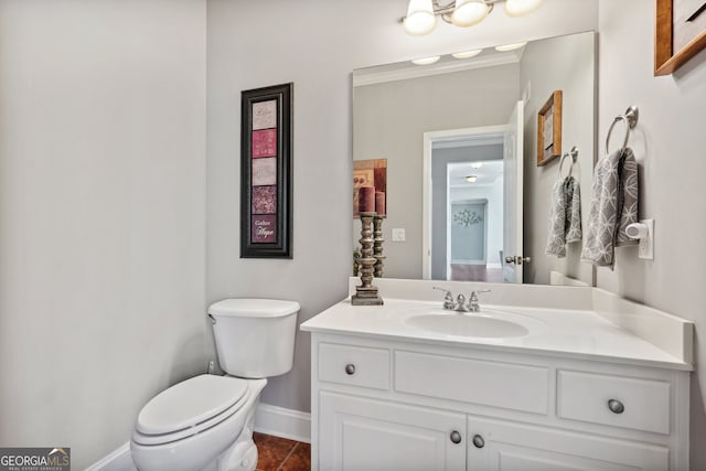 bathroom featuring tile patterned flooring, vanity, and toilet