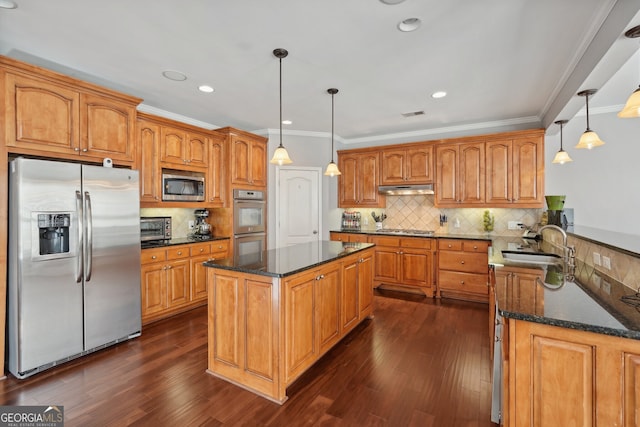 kitchen with stainless steel appliances, sink, pendant lighting, a center island, and dark hardwood / wood-style floors