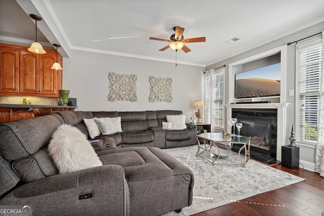 living room with ceiling fan, crown molding, and dark hardwood / wood-style floors