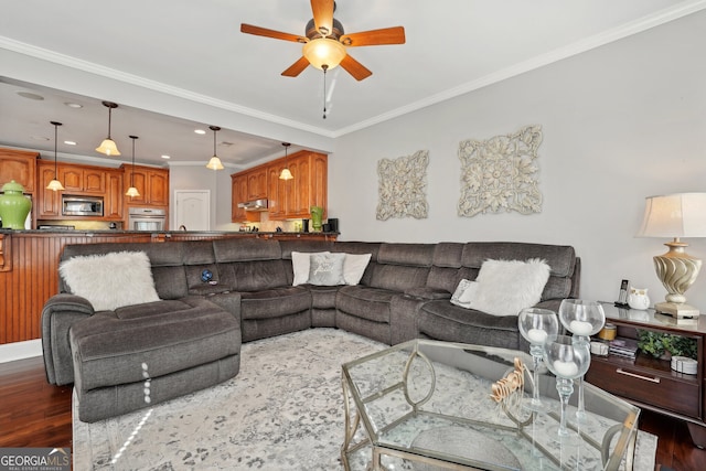 living room with dark hardwood / wood-style flooring, ceiling fan, and ornamental molding