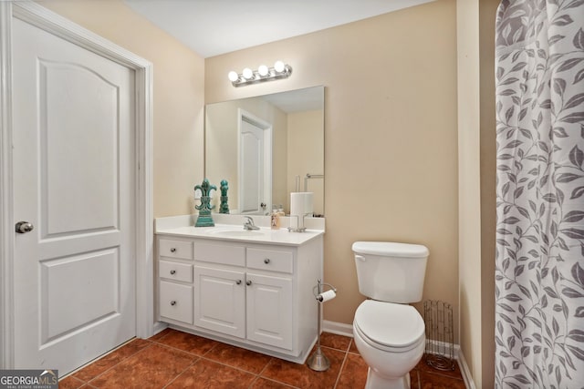 bathroom with toilet, vanity, and tile patterned floors