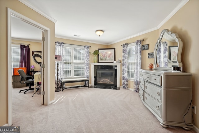 sitting room with crown molding, a high end fireplace, and light colored carpet