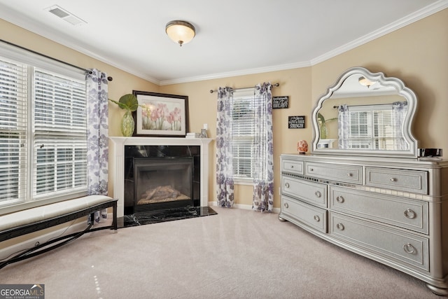 sitting room with carpet flooring, ornamental molding, and a premium fireplace