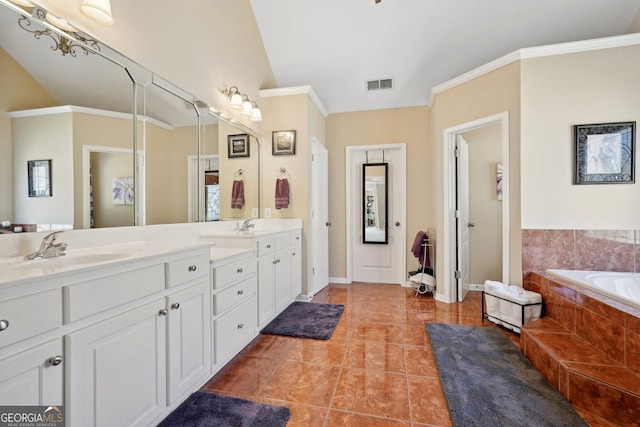 bathroom featuring tiled bath, tile patterned flooring, vanity, and ornamental molding