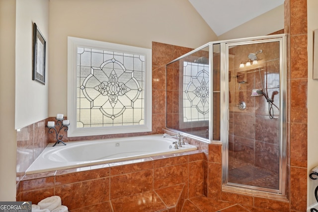 bathroom with tile patterned flooring, lofted ceiling, and shower with separate bathtub