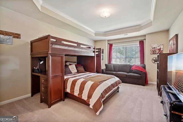 bedroom featuring a tray ceiling, crown molding, and light colored carpet