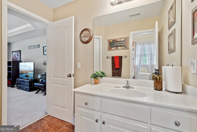 bathroom with tile patterned floors, crown molding, and vanity