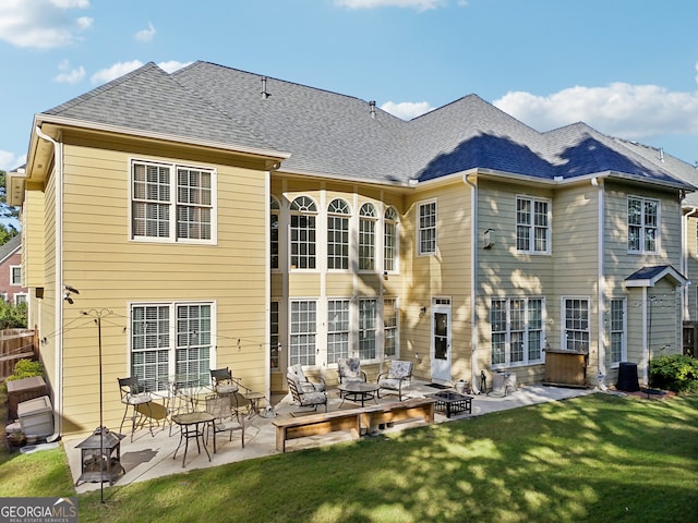 back of property featuring a yard and a patio