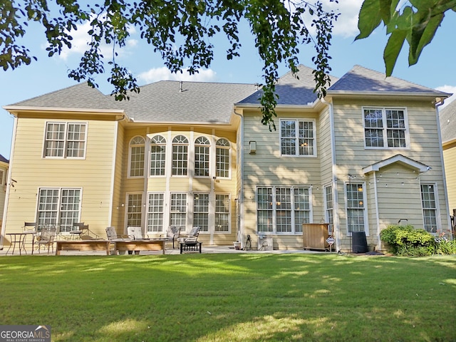 back of property with a patio and a lawn