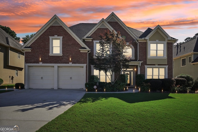 view of front property featuring a yard and a garage