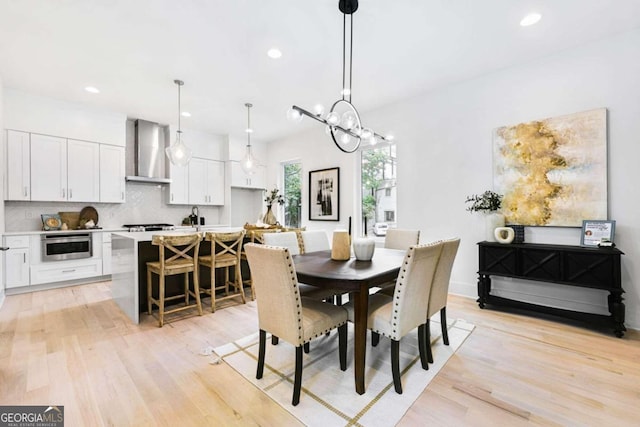 dining area featuring sink and light hardwood / wood-style floors