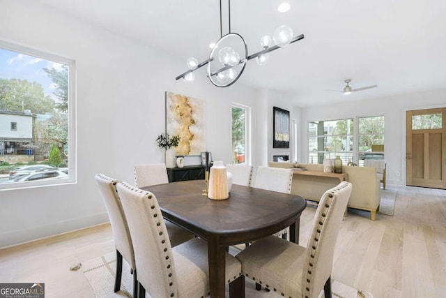 dining space featuring light hardwood / wood-style flooring, ceiling fan, and a healthy amount of sunlight