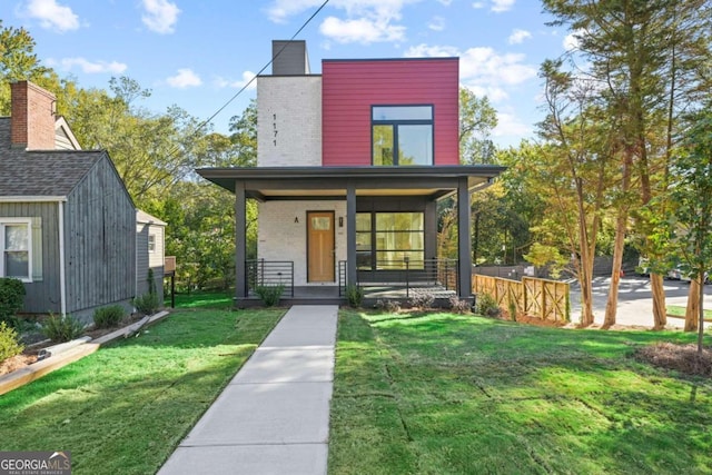 view of front of house with a porch and a front lawn