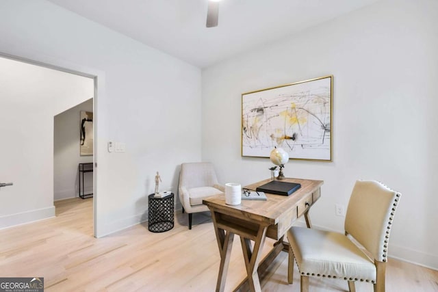 home office featuring light hardwood / wood-style flooring and ceiling fan