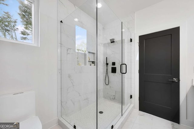 bathroom featuring a shower with shower door