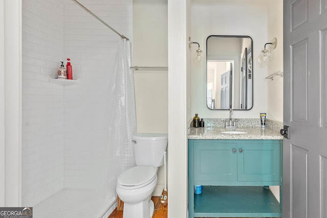 bathroom featuring vanity, toilet, and curtained shower